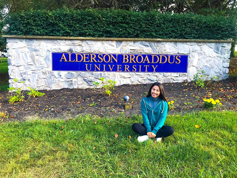 INP students in the landmark entrance of Alderson Broaddus University.
